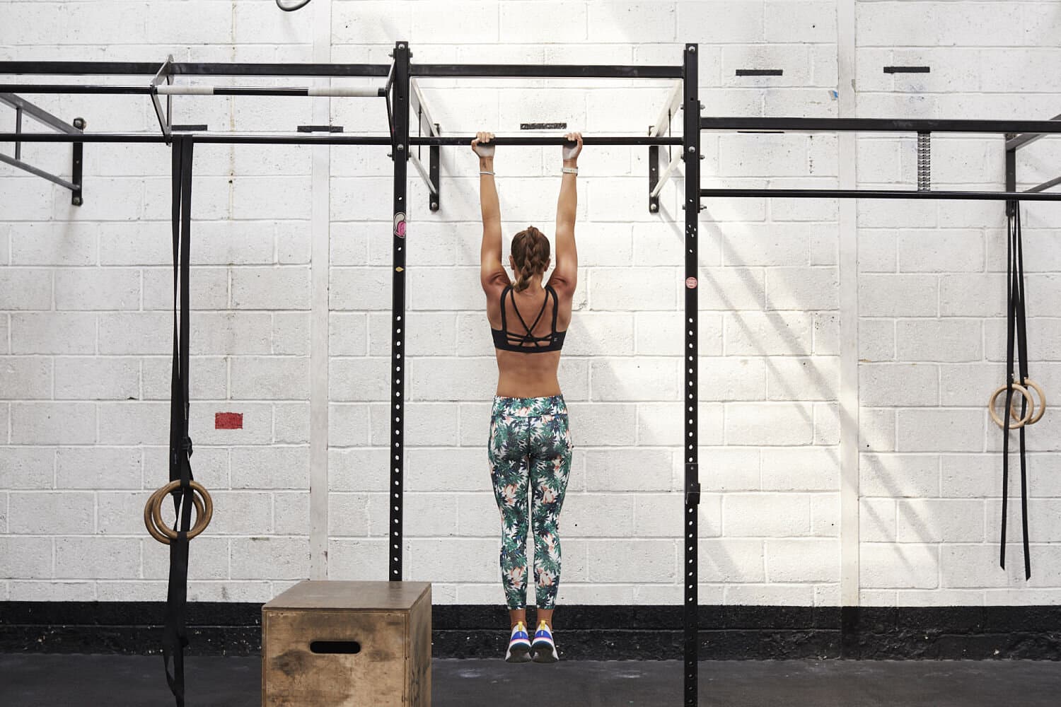 Fit woman dead hanging from a bar in the gym